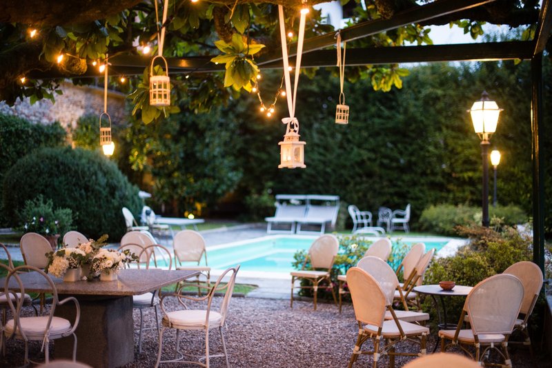 Poolside party space with hanging lanterns and string lights