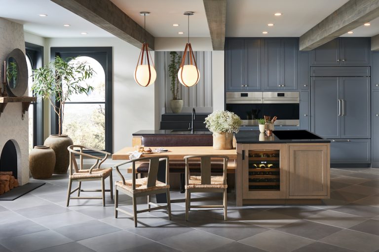Modern kitchen with a large island, bar seating, pendant lights and integrated appliances