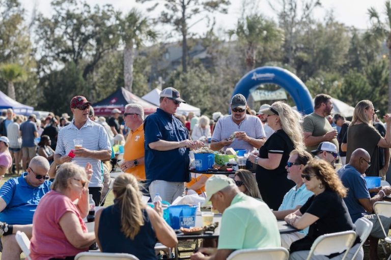 Festivalgoers gather around outdoor tables at the Hilton Head Island Oyster Festival.