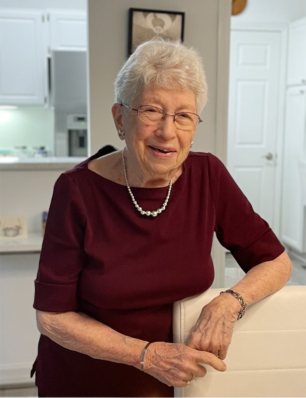 Portrait of Rhoda Shulman wearing glasses and a burgundy top