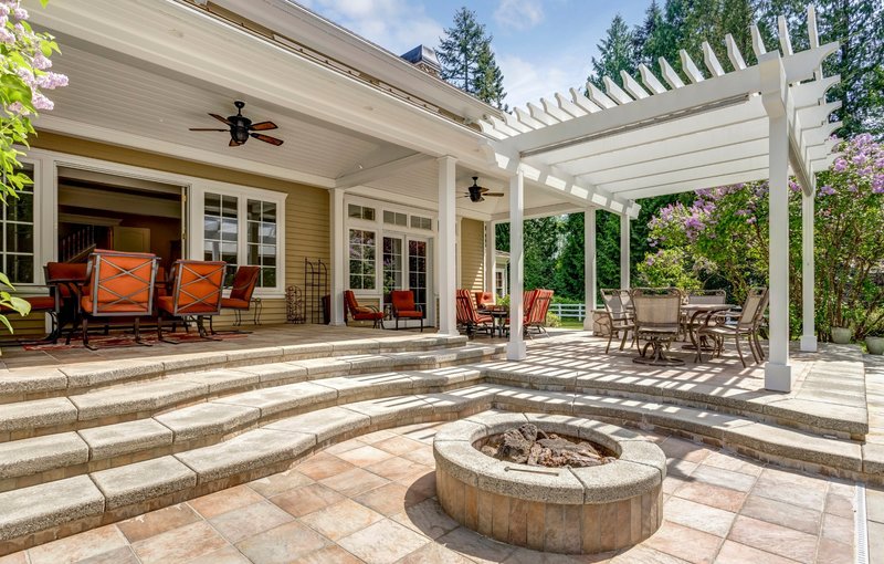 Covered patio with seating, ceiling fan and outdoor fire pit