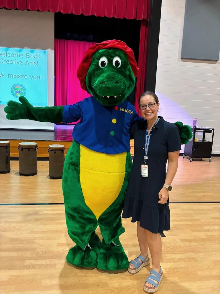 Principal Staci Souhan stands with the school mascot at Hilton Head Island Elementary School for the Creative Arts
