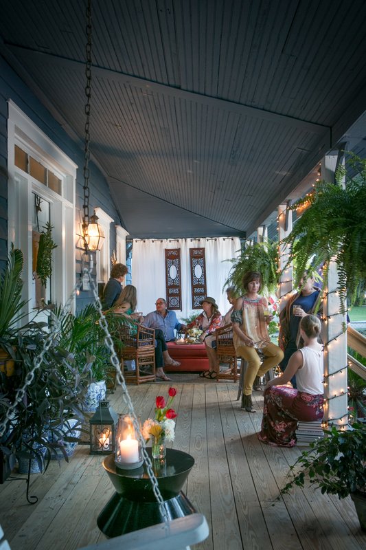 Guests relaxing together on a covered porch in Bluffton