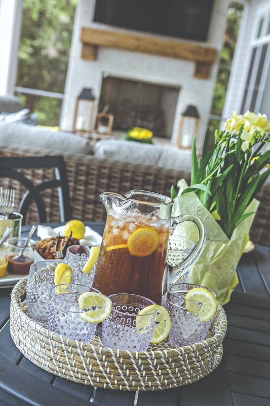 Pitchers and glasses of iced drinks arranged outdoors
